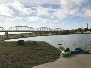 Life Updates - Kayaks on the river with the historic bridge